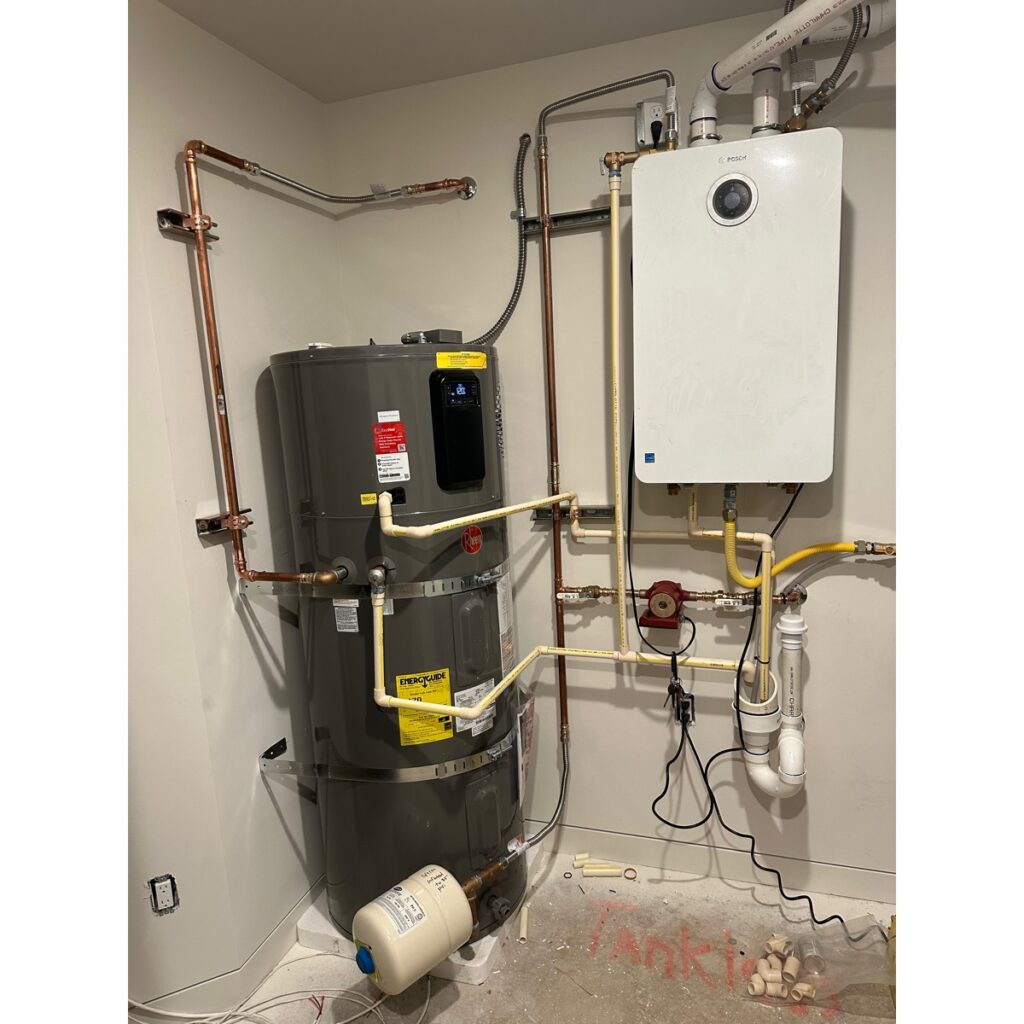 Rheem heat pump tank with a Bosch tankless water heater installed alongside it in a Kirkland utility room